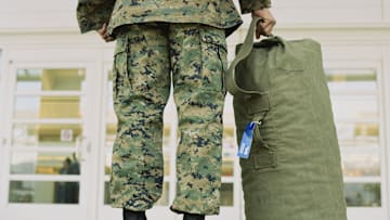 A soldier and his duffel bag.