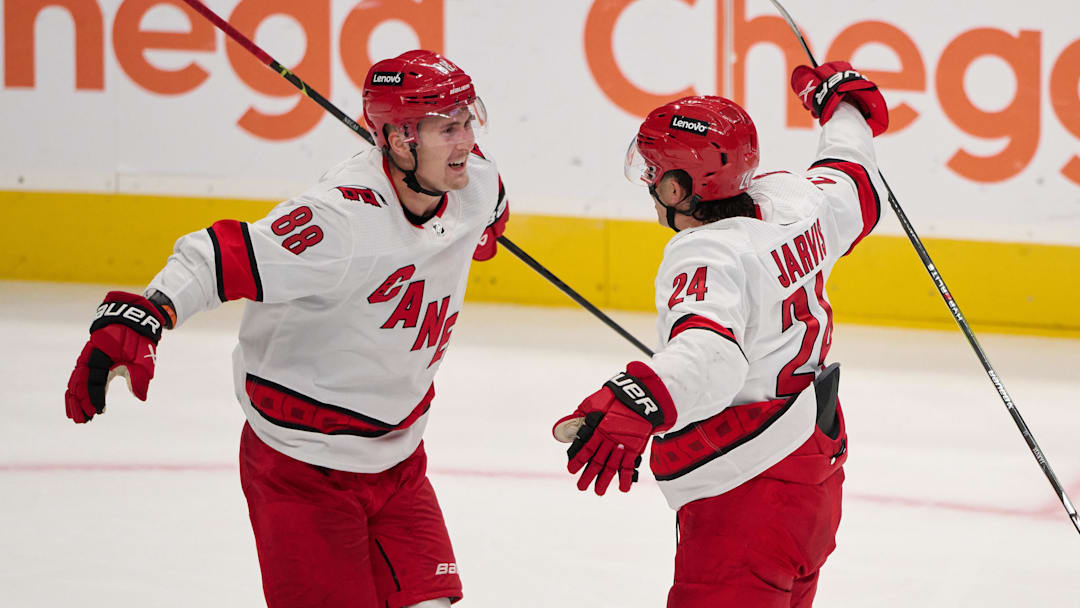 Oct 17, 2023; San Jose, California, USA; Carolina Hurricanes center Seth Jarvis (24) celebrates with center Martin Necas (88) after scoring a goal against the San Jose Sharks during the third period at SAP Center at San Jose. Mandatory Credit: Robert Edwards-Imagn Images