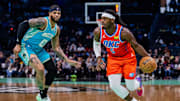 Apr 7, 2024; Charlotte, North Carolina, USA; Oklahoma City Thunder guard Luguentz Dort (5) drives by Charlotte Hornets forward Miles Bridges (0) during the first quarter at Spectrum Center. Mandatory Credit: Scott Kinser-Imagn Images