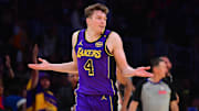Nov 19, 2024; Los Angeles, California, USA; Los Angeles Lakers guard Dalton Knecht (4) react after scoring a three point basket against the Utah Jazz during the second half at Crypto.com Arena. Mandatory Credit: Gary A. Vasquez-Imagn Images