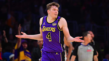 Nov 19, 2024; Los Angeles, California, USA; Los Angeles Lakers guard Dalton Knecht (4) react after scoring a three point basket against the Utah Jazz during the second half at Crypto.com Arena. Mandatory Credit: Gary A. Vasquez-Imagn Images