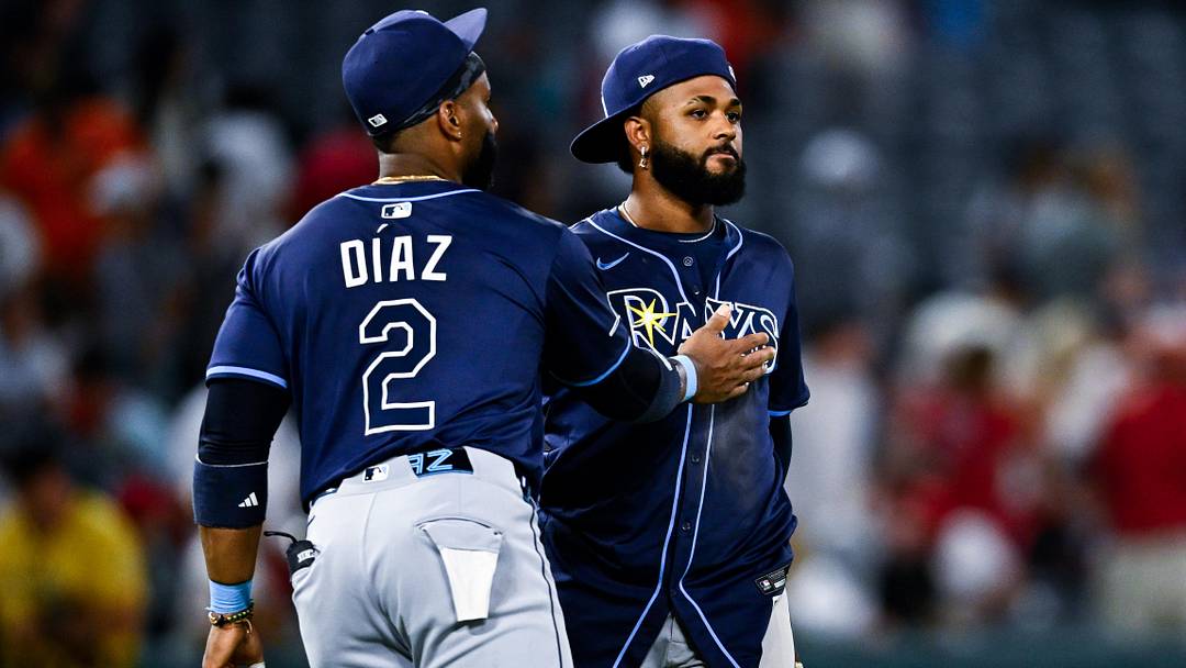 Aug 5, 2025; Anaheim, California, USA; Tampa Bay Rays first baseman Yandy Diaz (2) and third baseman Junior Caminero (13) celebrate after the game against the Los Angeles Angels at Angel Stadium of Anaheim.