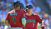 Aug 31, 2025; Los Angeles, California, USA;  Arizona Diamondbacks left fielder Corbin Carroll (7) is congratulated by second baseman Ketel Marte (4) after crossing the plate a  three-run home run during the eighth inning off Los Angeles Dodgers relief pitcher Tanner Scott (66) at Dodger Stadium. Mandatory Credit: Jayne Kamin-Oncea-Imagn Images