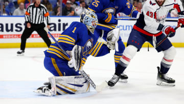 Apr 11, 2024; Buffalo, New York, USA;  Washington Capitals right wing Tom Wilson (43) tries to deflect a shot as Buffalo Sabres goaltender Ukko-Pekka Luukkonen (1) makes a save during the first period at KeyBank Center. Mandatory Credit: Timothy T. Ludwig-USA TODAY Sports