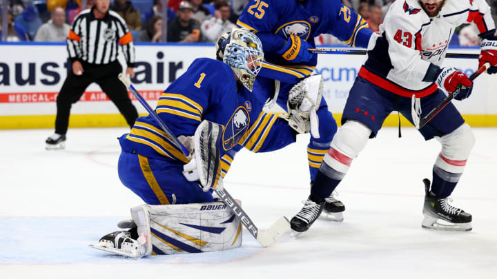 Apr 11, 2024; Buffalo, New York, USA;  Washington Capitals right wing Tom Wilson (43) tries to deflect a shot as Buffalo Sabres goaltender Ukko-Pekka Luukkonen (1) makes a save during the first period at KeyBank Center. Mandatory Credit: Timothy T. Ludwig-USA TODAY Sports