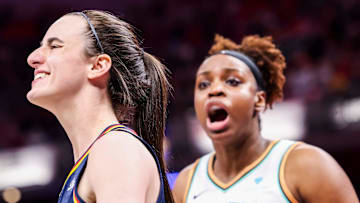 Indiana Fever guard Caitlin Clark (22) smiles while New York Liberty forward Kennedy Burke (22) expresses frustration Saturday, June 14, 2025, during a game between the Indiana Fever and the New York Liberty at Gainbridge Fieldhouse in Indianapolis. The Indiana Fever defeated the New York Liberty, 102-88.