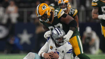 Green Bay Packers defensive tackle Kenny Clark (97) is called for a facemask penalty while tackling Dallas Cowboys quarterback Dak Prescott (4) during the third quarter of the wild card playoff game Sunday, January 14, 2024 at AT&T Stadium in Arlington, Texas.