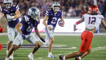 Sep 13, 2024; Manhattan, Kansas, USA; Kansas State Wildcats quarterback Avery Johnson (2) looks for room to run against Arizona Wildcats defensive back Genesis Smith (12) during the fourth quarter  at Bill Snyder Family Football Stadium. Mandatory Credit: Scott Sewell-Imagn Images