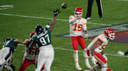 Chiefs quarterback Patrick Mahomes looks for an opening in the defense as Eagles lineman Javon Hargrave gets in his face during Super Bowl 57.