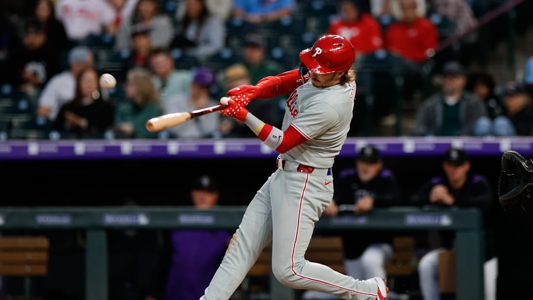 May 20, 2025; Denver, Colorado, USA; Philadelphia Phillies second baseman Bryson Stott (5) hits a single in the sixth inning against the Colorado Rockies at Coors Field. 