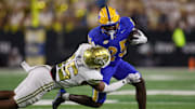 Nov 22, 2025; Atlanta, Georgia, USA; Pittsburgh Panthers running back Ja'Kyrian Turner (25) is tackled by Georgia Tech Yellow Jackets defensive back Kelvin Hill (16) in the first quarter at Bobby Dodd Stadium at Hyundai Field. Mandatory Credit: Brett Davis-Imagn Images