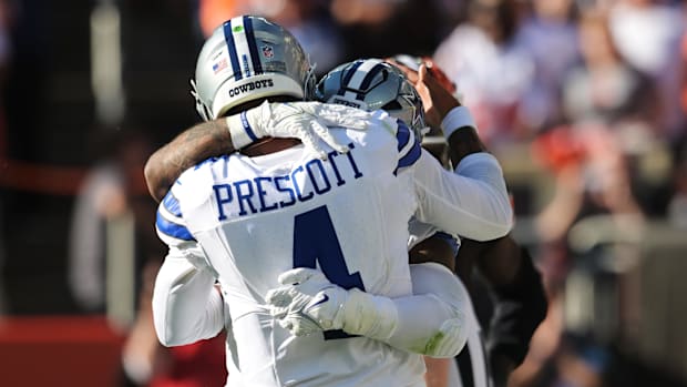 Dallas Cowboys quarterback Dak Prescott (4) celebrates with running back Ezekiel Elliott (15) after a touchdown