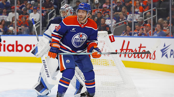 Sep 22, 2024; Edmonton, Alberta, CAN; Edmonton Oilers forward Mike Hoffman (68) tries to screen Winnipeg Jets goaltender Eric Comrie (1) during the first period at Rogers Place. Mandatory Credit: Perry Nelson-Imagn Images