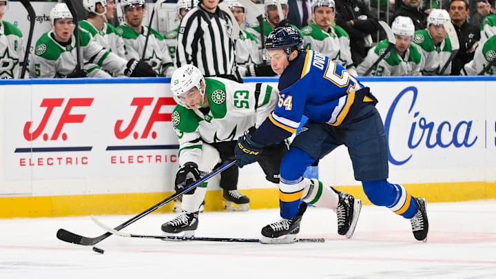 Jan 27, 2026; St. Louis, Missouri, USA; St. Louis Blues right wing Dalibor Dvorsky (54) slashes Dallas Stars center Wyatt Johnston (53) during the second period at Enterprise Center. Mandatory Credit: Jeff Curry-Imagn Images