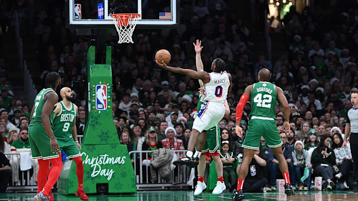 Dec 25, 2024; Boston, Massachusetts, USA; Philadelphia 76ers guard Tyrese Maxey (0) shoot a layup against the Boston Celtics during the second half at TD Garden. Mandatory Credit: Eric Canha-Imagn Images