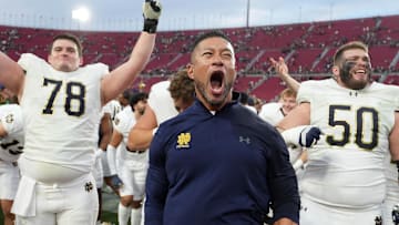 Notre Dame Fighting Irish head coach Marcus Freeman celebrates with players at the end of the game against the Southern California Trojans