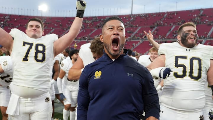 Notre Dame Fighting Irish head coach Marcus Freeman celebrates with players at the end of the game against the Southern California Trojans