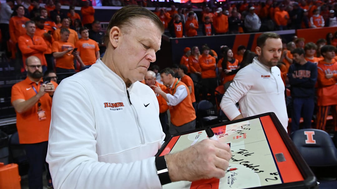 Feb 4, 2026; Champaign, Illinois, USA;  Illinois Fighting Illini head coach Brad Underwood prepares his game plan before tip-off against the Northwestern Wildcats at State Farm Center. Mandatory Credit: Ron Johnson-Imagn Images