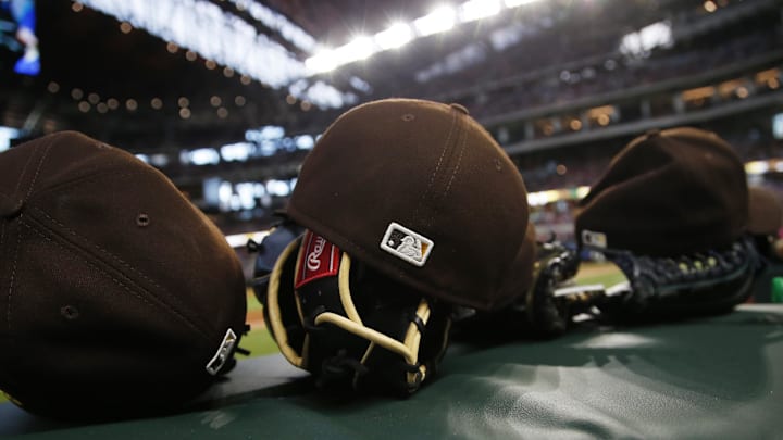 A general view of gloves and hats during the game between the San Diego Padres and the Texas Rangers at Globe Life Field. A general view of gloves and hats during the game between the San Diego Padres and the Texas Rangers at Globe Life Field.