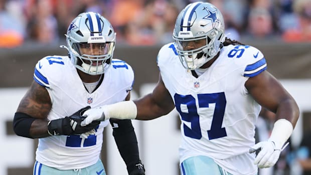 Dallas Cowboys linebacker Micah Parsons (11) celebrates with defensive tackle Osa Odighizuwa (97) 