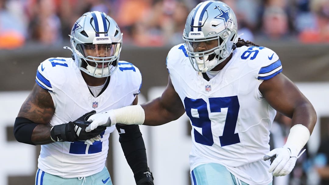 Dallas Cowboys linebacker Micah Parsons (11) celebrates with defensive tackle Osa Odighizuwa (97) after a sack during the first quarter against the Cleveland Browns at Huntington Bank Field.