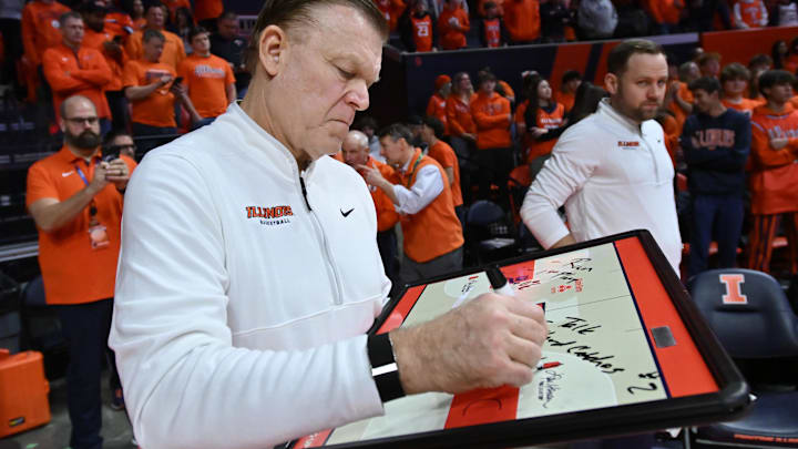 Feb 4, 2026; Champaign, Illinois, USA;  Illinois Fighting Illini head coach Brad Underwood prepares his game plan before tip-off against the Northwestern Wildcats at State Farm Center. Mandatory Credit: Ron Johnson-Imagn Images
