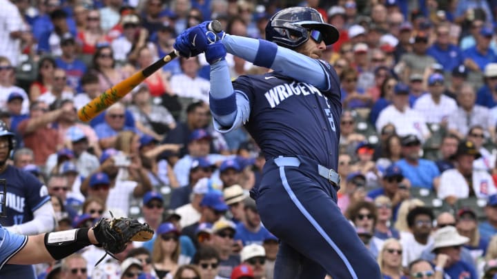 Aug 16, 2024; Chicago, Illinois, USA;  Chicago Cubs outfielder Cody Bellinger (24) hits a two run home run against the Toronto Blue Jays during the first inning at Wrigley Field.