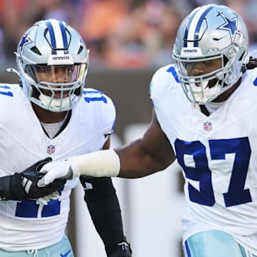 Dallas Cowboys EDGE Micah Parsons celebrates with defensive tackle Osa Odighizuwa after a sack during the first quarter against the Cleveland Browns at Huntington Bank Field.