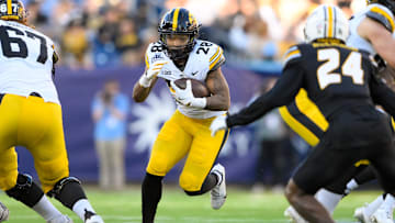 Dec 30, 2024; Nashville, TN, USA;  Iowa Hawkeyes running back Kamari Moulton (28) runs the ball against the Missouri Tigers during the first half at Nissan Stadium. Mandatory Credit: Steve Roberts-Imagn Images