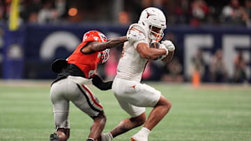 Dec 7, 2024; Atlanta, GA, USA; Georgia Bulldogs defensive back KJ Bolden (4) makes a tackle on Texas Longhorns wide receiver DeAndre Moore Jr. (0) during the first half in the 2024 SEC Championship game at Mercedes-Benz Stadium. Mandatory Credit: Dale Zanine-Imagn Images