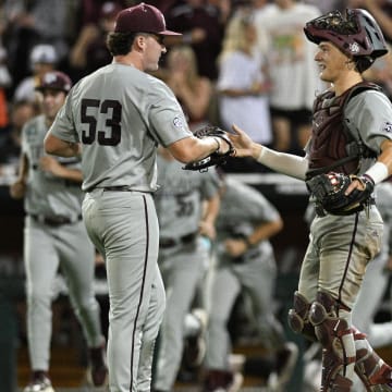 Jun 22, 2024; Omaha, NE, USA; Texas A&M Aggies pitcher Evan Aschenbeck (53) and catcher Jackson Appel (20) celebrate after defeating the Tennessee Volunteers at Charles Schwab Field Omaha. 