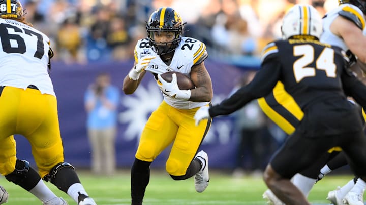 Dec 30, 2024; Nashville, TN, USA;  Iowa Hawkeyes running back Kamari Moulton (28) runs the ball against the Missouri Tigers during the first half at Nissan Stadium. Mandatory Credit: Steve Roberts-Imagn Images