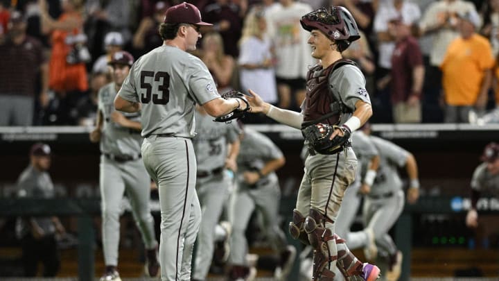 Jun 22, 2024; Omaha, NE, USA; Texas A&M Aggies pitcher Evan Aschenbeck (53) and catcher Jackson Appel (20) celebrate after defeating the Tennessee Volunteers at Charles Schwab Field Omaha. 