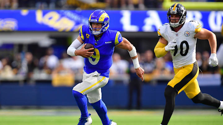 Oct 22, 2023; Inglewood, California, USA; Los Angeles Rams quarterback Matthew Stafford (9) runs the ball ahead of Pittsburgh Steelers linebacker T.J. Watt (90) during the second half at SoFi Stadium. Mandatory Credit: Gary A. Vasquez-Imagn Images
