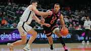 Jan 29, 2025; Coral Gables, Florida, USA; Miami Hurricanes guard Matthew Cleveland (0) drives to the basket against past Virginia Cavaliers guard Taine Murray (10) during the second half at Watsco Center. Mandatory Credit: Sam Navarro-Imagn Images