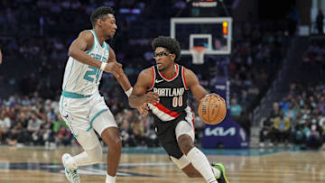 Apr 3, 2024; Charlotte, North Carolina, USA; Portland Trail Blazers guard Scoot Henderson (00) drives to the basket against Charlotte Hornets forward Brandon Miller (24) during the first quarter at Spectrum Center. Mandatory Credit: Jim Dedmon-Imagn Images