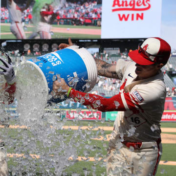 Jun 9, 2024; Anaheim, California, USA;  Los Angeles Angels catcher Logan O'Hoppe is doused with ice and sports drink by shortstop Zach Neto (left) and center fielder Mickey Moniak (right) after hitting a game winning walk off home run in bottom of the ninth inning against the Houston Astros at Angel Stadium. Mandatory Credit: Kiyoshi Mio-USA TODAY Sports