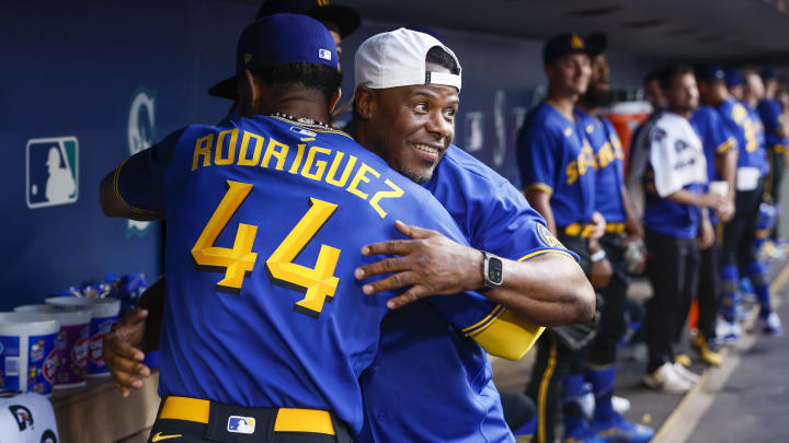 Seattle Mariners center fielder Julio Rodriguez (44) hugs former outfielder Ken Griffey, Jr., on Aug. 23, 2023, at T-Mobile Park.