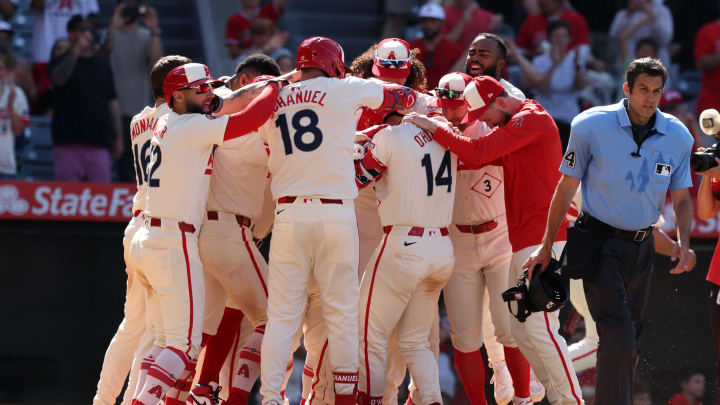 Jun 9, 2024; Anaheim, California, USA;  Los Angeles Angels catcher Logan O'Hoppe (14) celebrates with teammates after hitting a game winning 2-run home run in bottom of the ninth inning against the Houston Astros at Angel Stadium. Mandatory Credit: Kiyoshi Mio-USA TODAY Sports