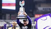 Dec 26, 2024; Phoenix, AZ, USA; Kansas State Wildcats head coach Chris Klieman celebrates with the trophy after defeating the Rutgers Scarlet Knights during the Rate Bowl at Chase Field. Mandatory Credit: Mark J. Rebilas-Imagn Images