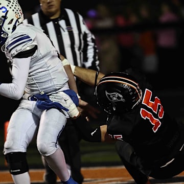 Ryle's Bo Gay (15) sacks Simon Kenton quarterback Grant Webb (5) during their football game Friday, Oct. 24, 2025, at Ryle High School.