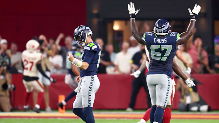 Seahawks quarterback Sam Darnold (14) and offensive tackle Charles Cross (67) celebrate a touchdown against the Cardinals Seahawks quarterback Sam Darnold (14) and offensive tackle Charles Cross (67) celebrate a touchdown against the Cardinals