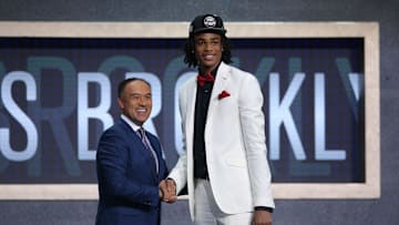 Jun 20, 2019; Brooklyn, NY, USA; Nicholas Claxton (Georgia) greets NBA deputy commissioner Mark Tatum after being selected as the number thirty-one overall pick to the Brooklyn Nets during the second round of the 2019 NBA Draft at Barclays Center. Mandatory Credit: Brad Penner-Imagn Images
