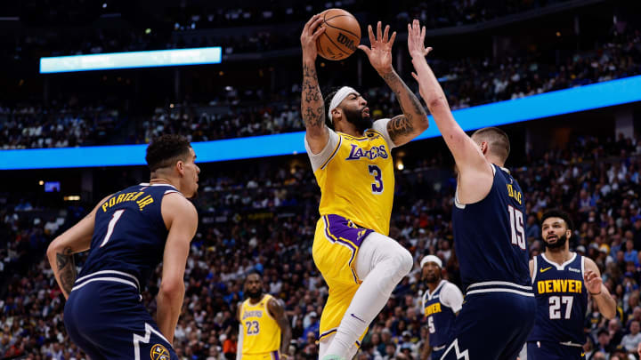 Apr 29, 2024; Denver, Colorado, USA; Los Angeles Lakers forward Anthony Davis (3) drives to the net against Denver Nuggets center Nikola Jokic (15) as forward Michael Porter Jr. (1) defends in the first quarter during game five of the first round for the 2024 NBA playoffs at Ball Arena. Mandatory Credit: Isaiah J. Downing-USA TODAY Sports