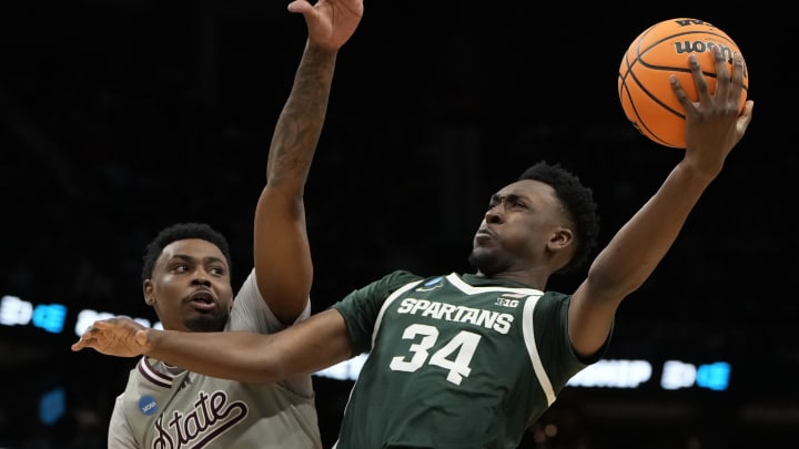 March 21, 2024, Charlotte, NC, USA; Michigan State Spartans forward Xavier Booker (34) shoots against Mississippi State Bulldogs forward D.J. Jeffries (0) in the first round of the 2024 NCAA Tournament at the Spectrum Center. Mandatory Credit: Bob Donnan-USA TODAY Sports