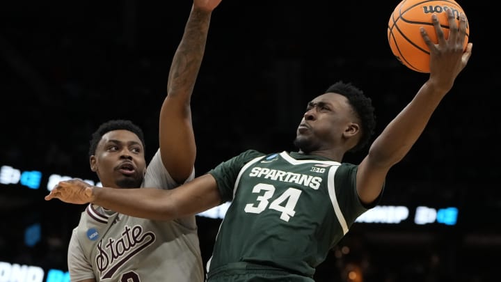 March 21, 2024, Charlotte, NC, USA; Michigan State Spartans forward Xavier Booker (34) shoots against Mississippi State Bulldogs forward D.J. Jeffries (0) in the first round of the 2024 NCAA Tournament at the Spectrum Center. Mandatory Credit: Bob Donnan-USA TODAY Sports