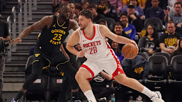 Nov 26, 2025; San Francisco, California, USA;  Houston Rockets center Alperen Sengun (28) drives against Golden State Warriors forward Draymond Green (23) in the second quarter at Chase Center. Mandatory Credit: David Gonzales-Imagn Images