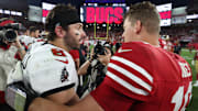 Tampa Bay Buccaneers quarterback Baker Mayfield (6) and San Francisco 49ers quarterback Mac Jones hug following their game.