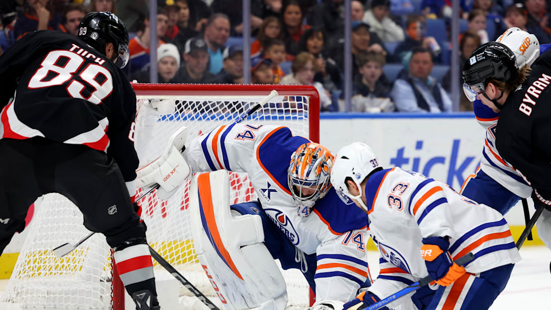 Edmonton Oilers goaltender Stuart Skinner (74) covers up the puck with his glove as Buffalo Sabres right wing Alex Tuch (89) 