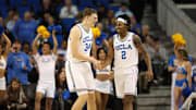 Jan 21, 2025; Los Angeles, California, USA;  UCLA Bruins guard Dylan Andrews (2) is greeted by forward Tyler Bilodeau (34) during the second half against the Wisconsin Badgers at Pauley Pavilion presented by Wescom. Mandatory Credit: Kiyoshi Mio-Imagn Images